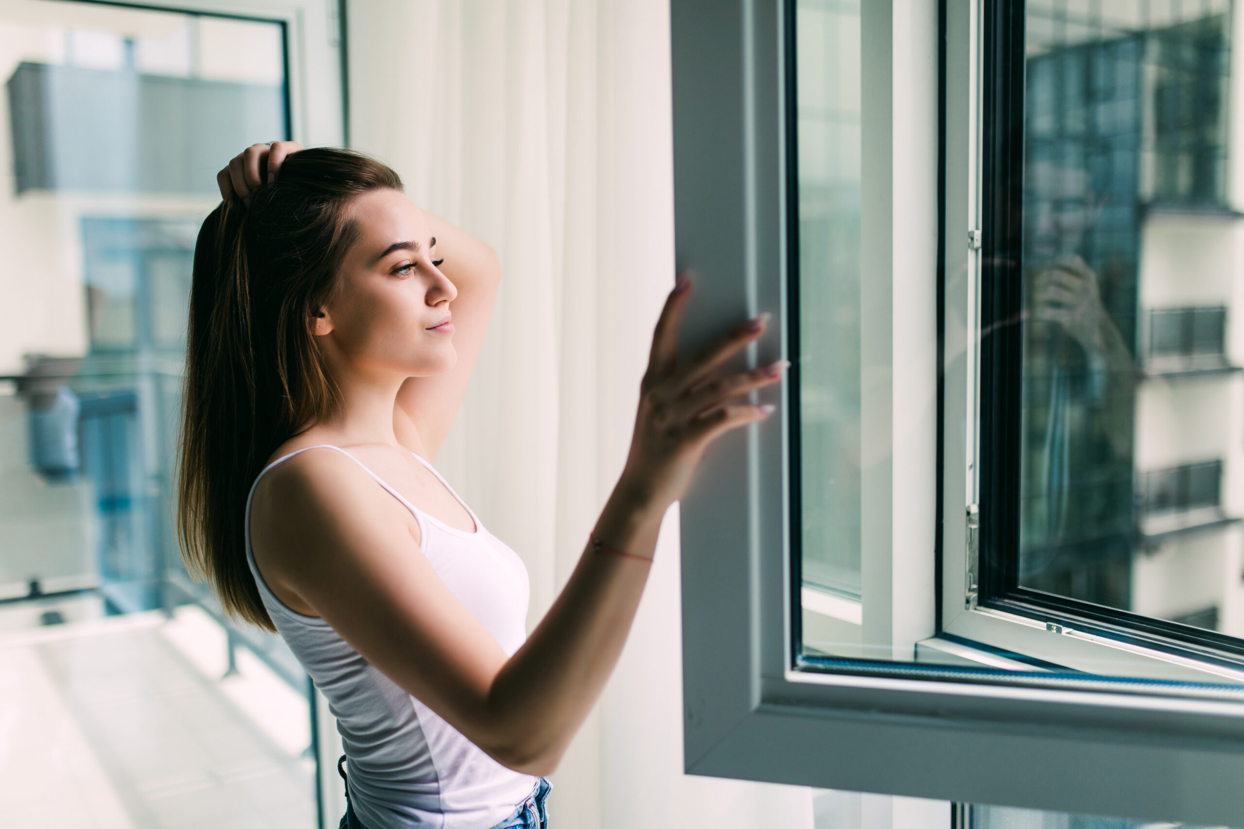 Woman opens a plastic window and smiling